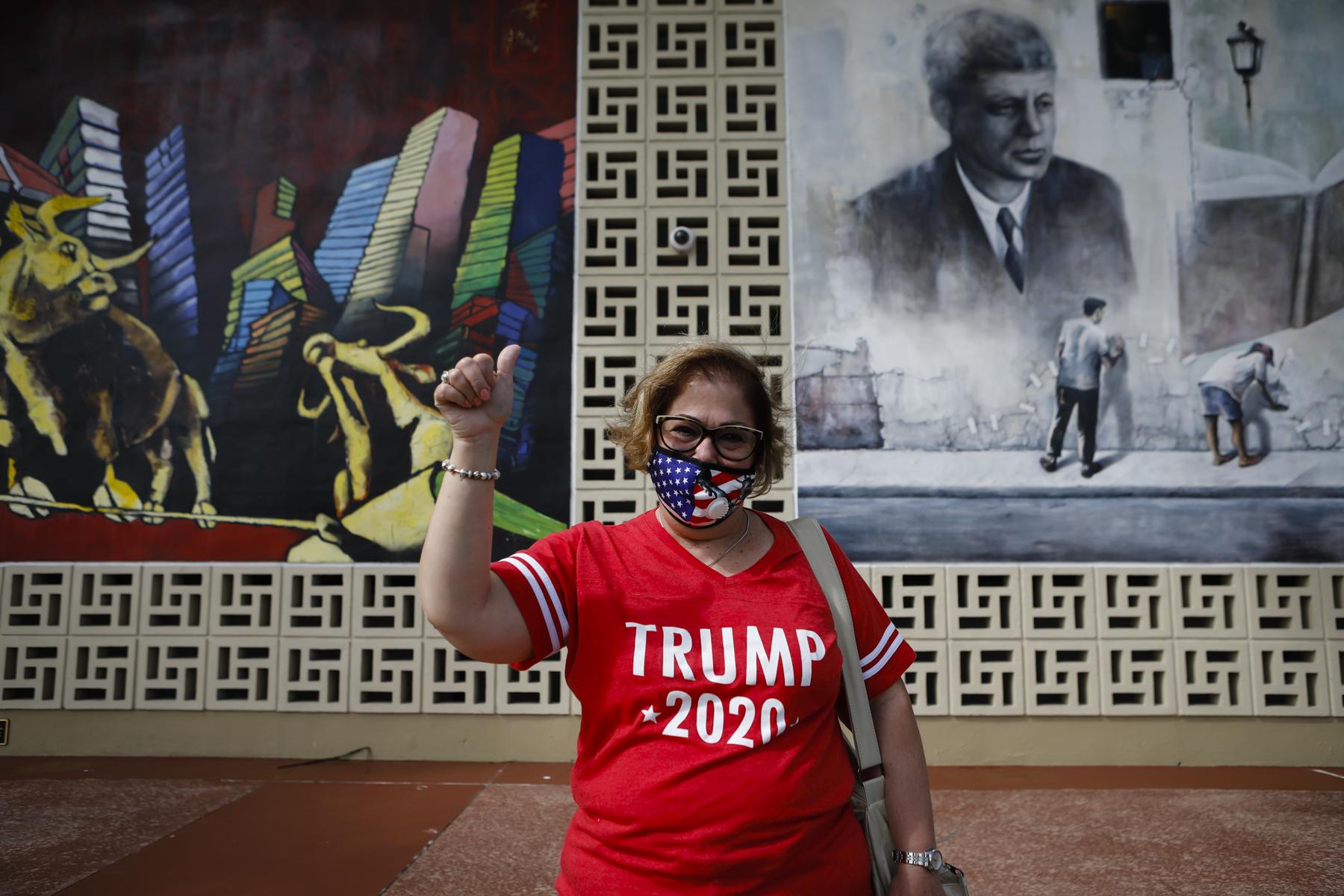 Election 2020 @ Miami, FL - A U.S. President Donald Trump supporter poses for a photo...