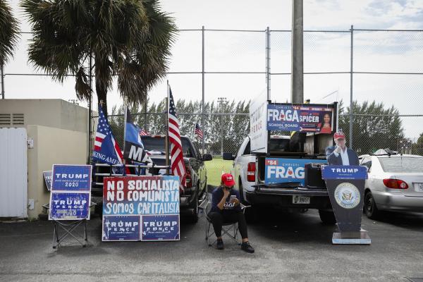Image from 2020 - Presidential Elections @ Miami, FL - A U.S. President Donald Trump supporter uses her phone...