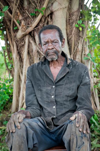 Image from Parenting the Missing - Odora Nakumiya sits in the garden by his house in Panyum...