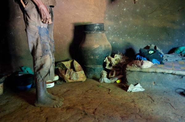 Image from Parenting the Missing - Odora Nakumiya stands in his hut in Panyum Obanlwane...