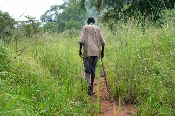 Parenting the Missing - Mukasa Joseph Okidi walks towards his compound in...