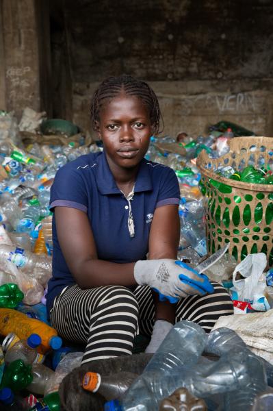 Image from Recycling Lagos  - Damilola Adetayo sorts plastic bottles and removes paper...