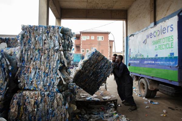 Image from Recycling Lagos  - Workers stack a bale of plastic bottles at the Berger...