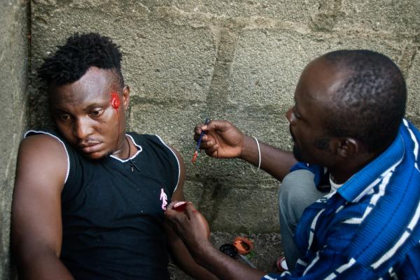 Image from Nollywood: Cinema of Nigeria -  Make-up artist Kpoyi Creation (right) preparing a...