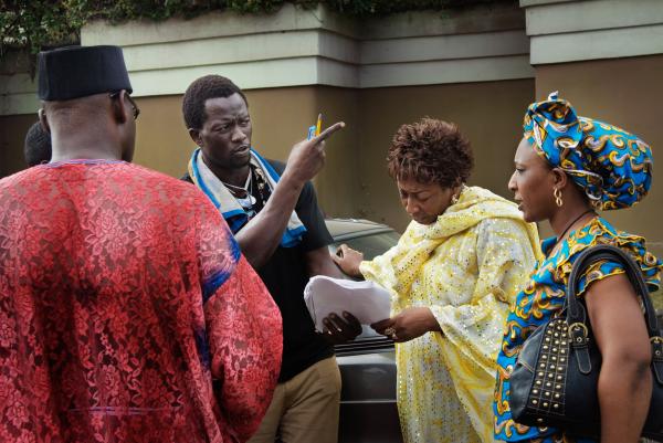 Image from Nollywood: Cinema of Nigeria - Film director Ola Orlando Shoyinka (left) discusses the...