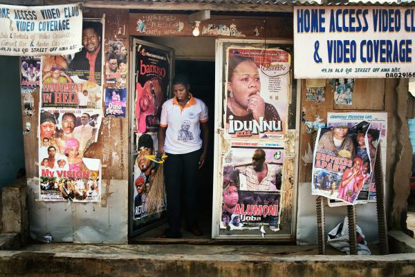 Nollywood: Cinema of Nigeria - Storekeeper walks out of a local video store that sells...