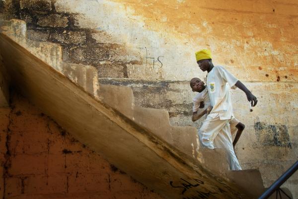 Image from NGO Work - Schoolmate carries Adamu Yusif, who is unable to walk due...
