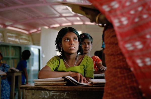 NGO Work - Ratna Khatun listens to her teacher during a lesson on a...