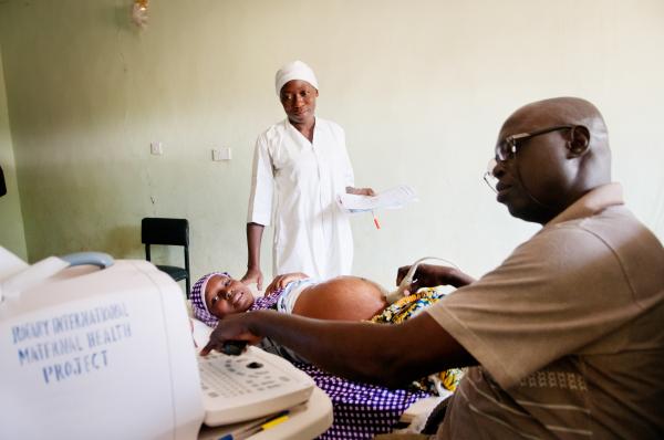 Image from NGO Work - Nurse Ladi Adamu watches as Dr. Salawuddeen explains the...