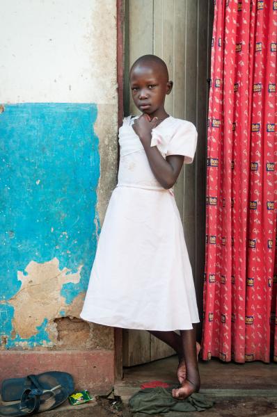 Image from NGO Work - Sharon Amukye's stands in front of her home. Sharon...