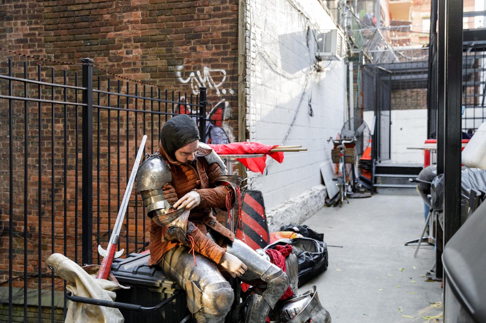 Luke Reich puts on his armor in the backyard of the Ground.