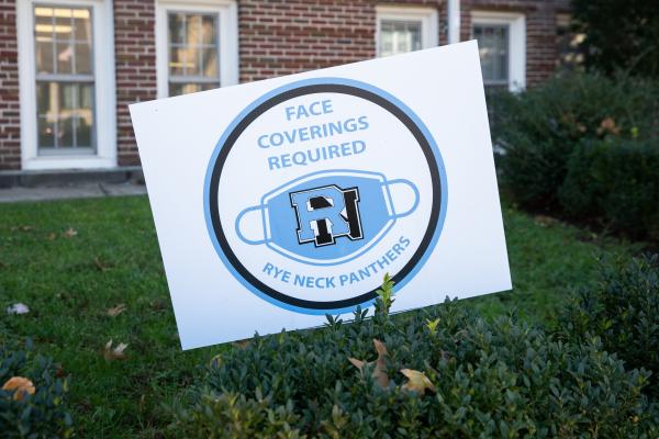 Spaces and Signs (COVID-19) - Outdoor signs remind students and staff that wearing face...
