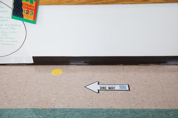 Spaces and Signs (COVID-19) - Arrow on the floor reminds students and staff on which...