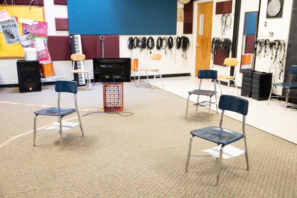 Image from Spaces and Signs (COVID-19) - Students sit six feet apart in the music room. Video feed...