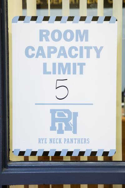 Spaces and Signs (COVID-19) - Poster outside of an office reminds students and staff to...