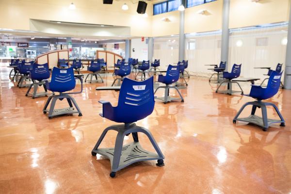 Spaces and Signs (COVID-19) - Chairs are spaced 6 feet apart in the cafeteria. Chairs...