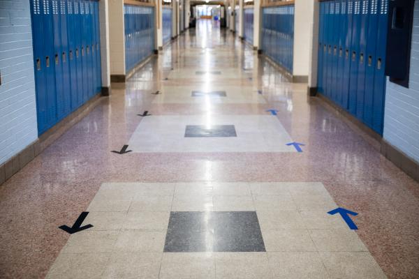 Image from Spaces and Signs (COVID-19) - Arrows on the floor remind students and staff on which...