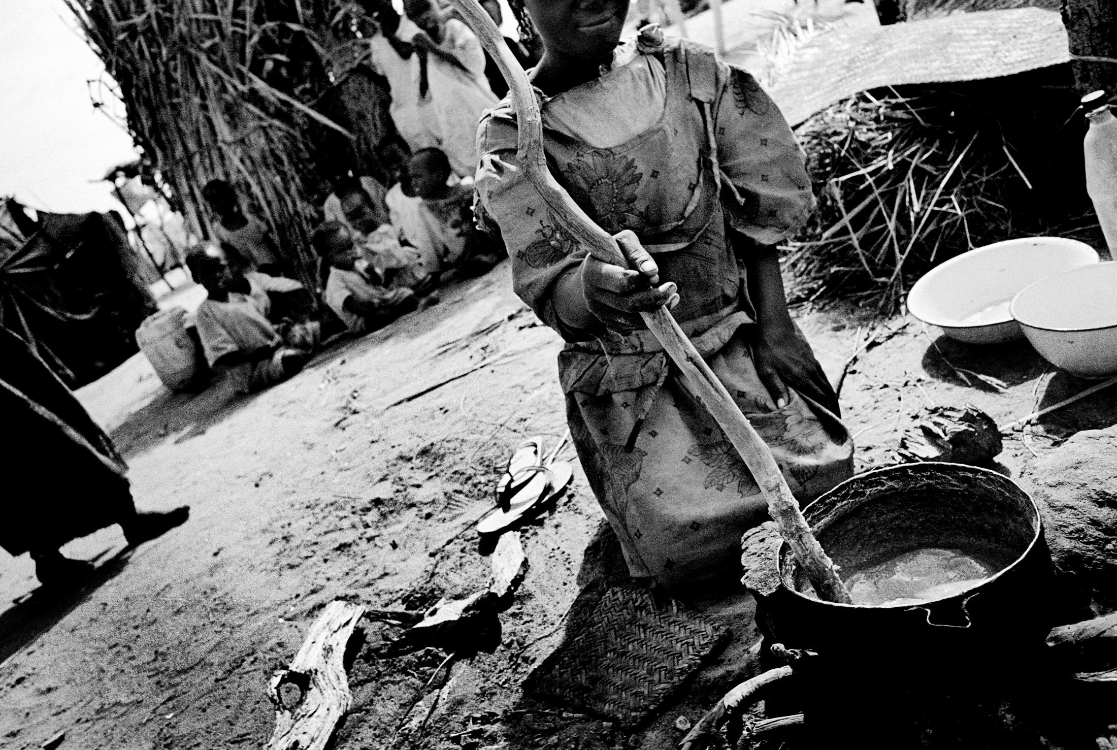 Darfur - SUDAN Nyala, South Darfur A young mother cooking at the...