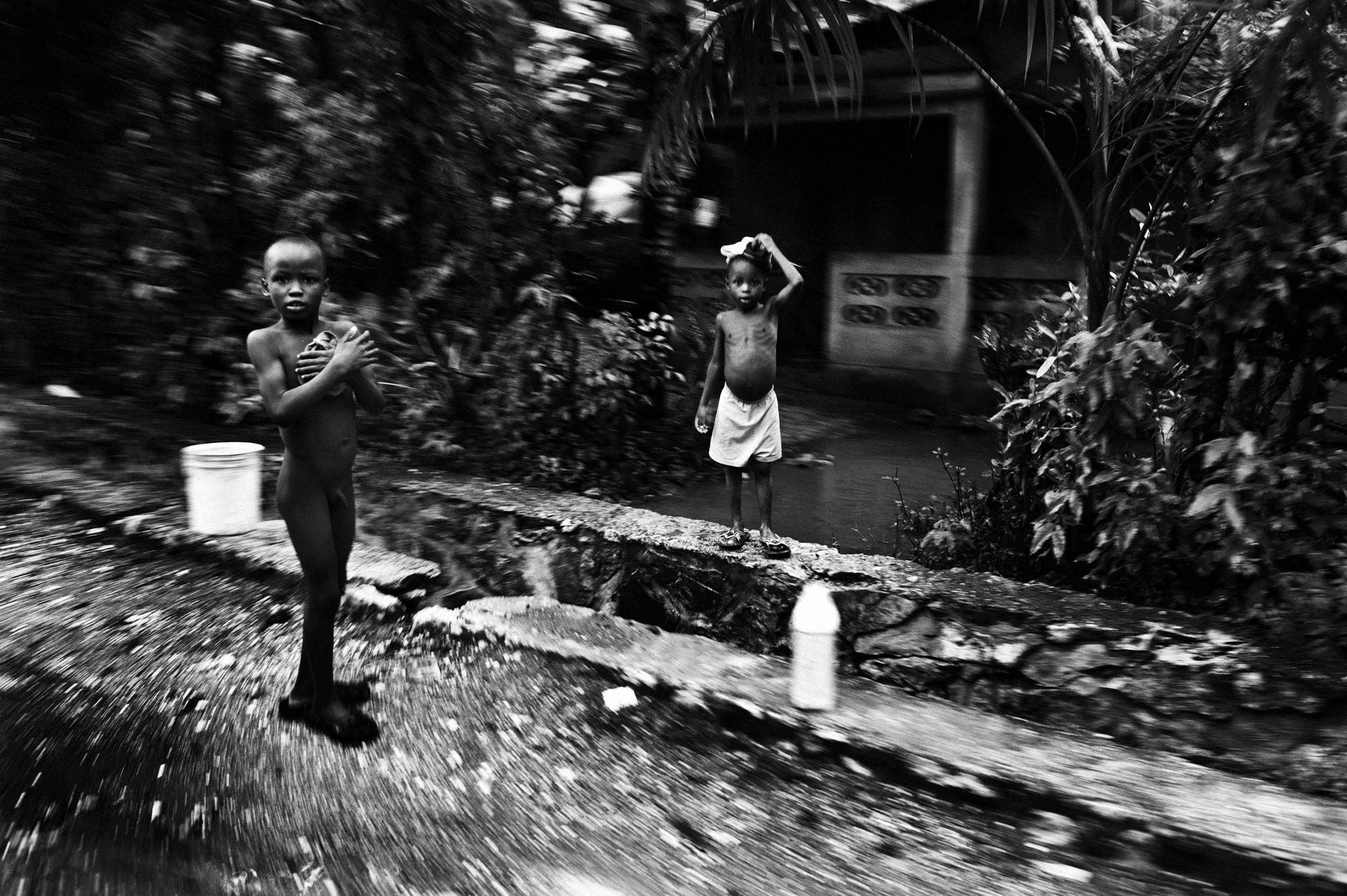 Private hell - Petit Guave.June 2010.Children in Petit Guave washing...