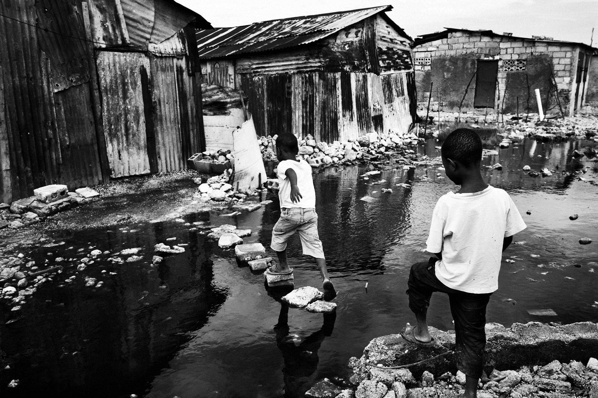 Private hell - Port au Prince.June 2010.Young children walking trough...