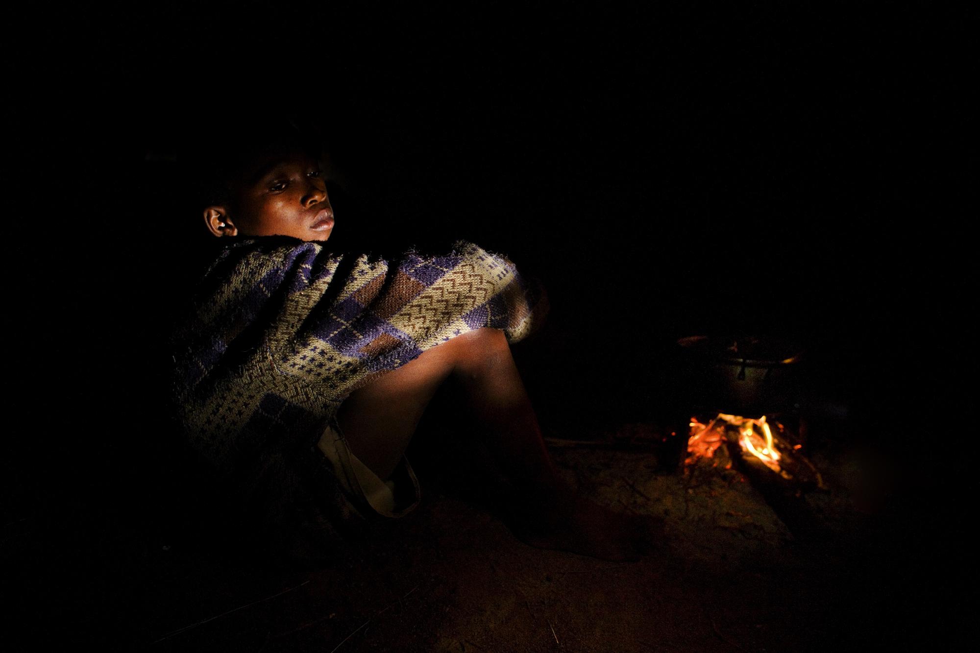 SwazilandÂ´s orphans  - Hosea, Swaziland.
Themba next to fire.
The parents were...