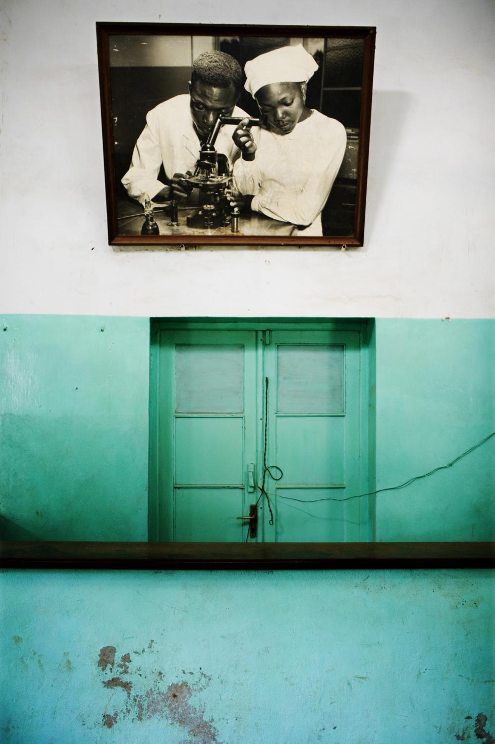 DEMOCRATIC REPUBLIC OF CONGO Bukavu, South Kivu Province An old framed photograph of a doctor and nurse looking through a microscope hangs at the...