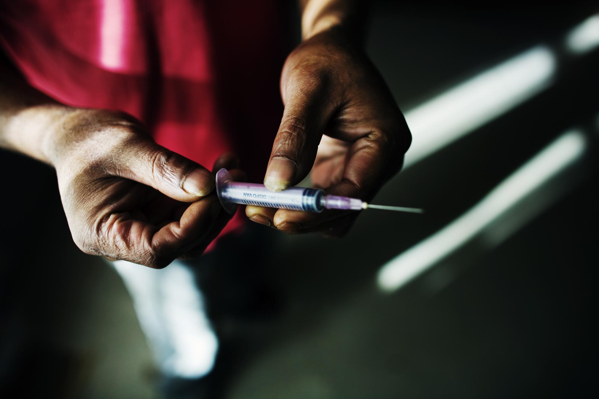 INDIA Aizawl, Mizoram A drug user showing the syringe that he uses to inject the drug spasmo proxyvon (SP), a cheap substitute for heroin and a very common drug in northeast India. Spasmo proxyvon often causes abscesses on the legs and other parts of the body when injected.