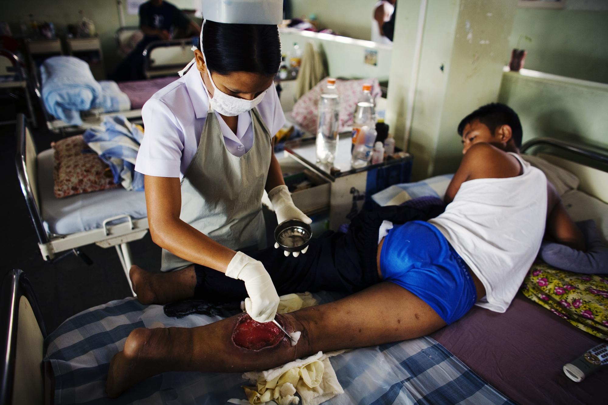 Injecting death - INDIA Aizawl, Mizoram A nurse helping to heal the wounds...