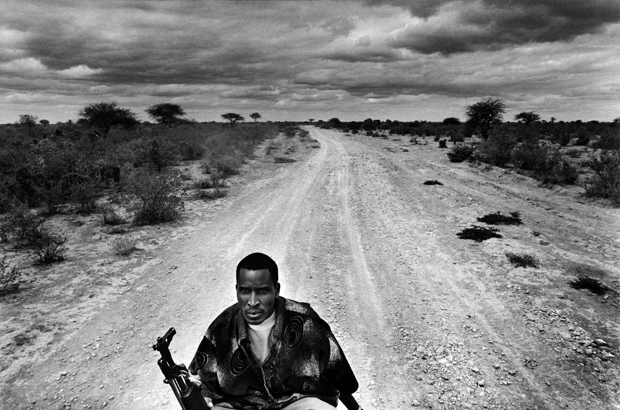 Somalia, the invisible trace - SOMALIA Eel Garas, Bakool An armed guard on the back of a...
