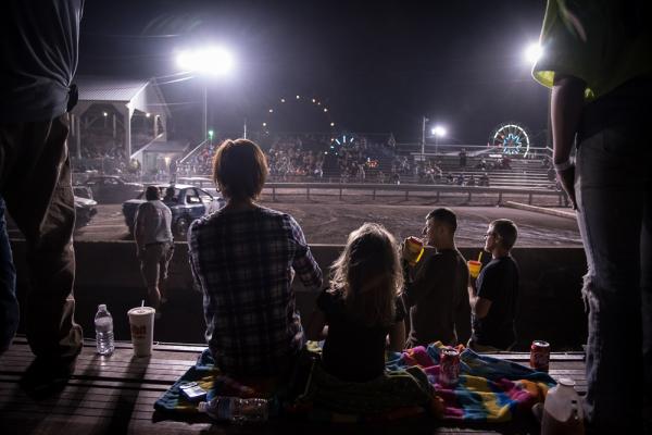 Image from Home/Land -   Families watching the tractor pull, Gratz Fair  