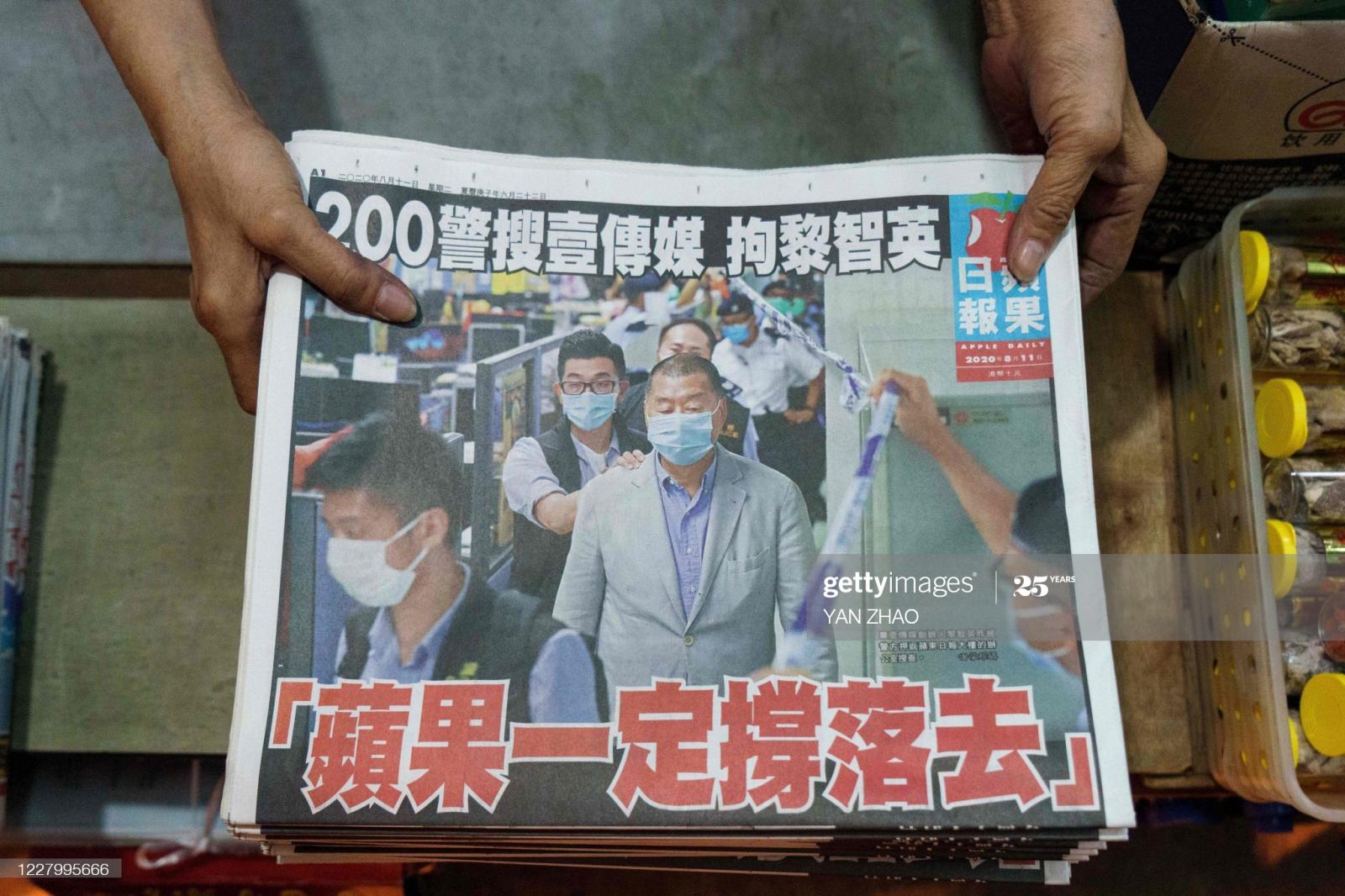 A vendor arranges fresh copies ... YAN ZHAO/AFP via Getty Images)