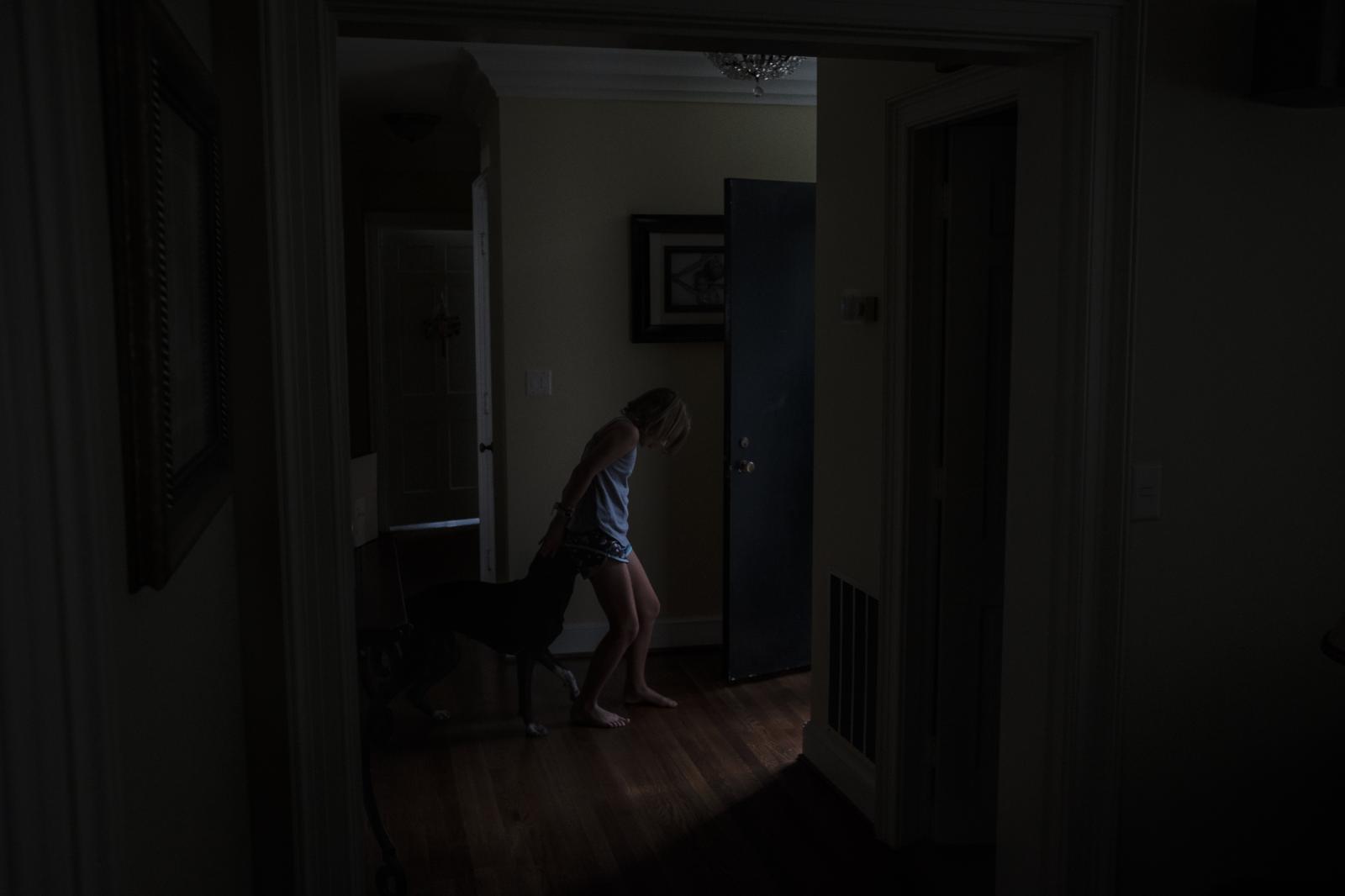 NPR - Hannah Seidman playing with her dog Quin in her house in...