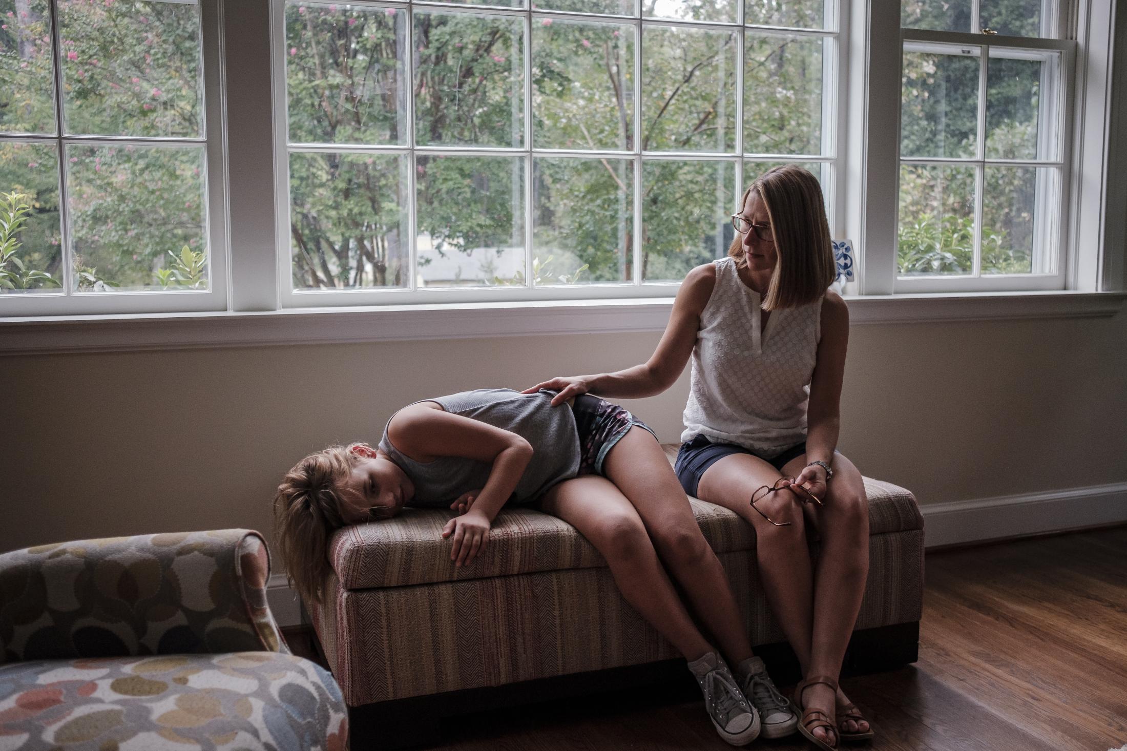Jeri Seidman and her daughter Hannah lounging at their house in Charlottesville, Virginia, U.S., on Monday Sept. 23, 2019. Hannah is a patient in a genetic risk study about type 1 diabetes at University of Virginia. Photographer: Carlos Bernate/ NPR
