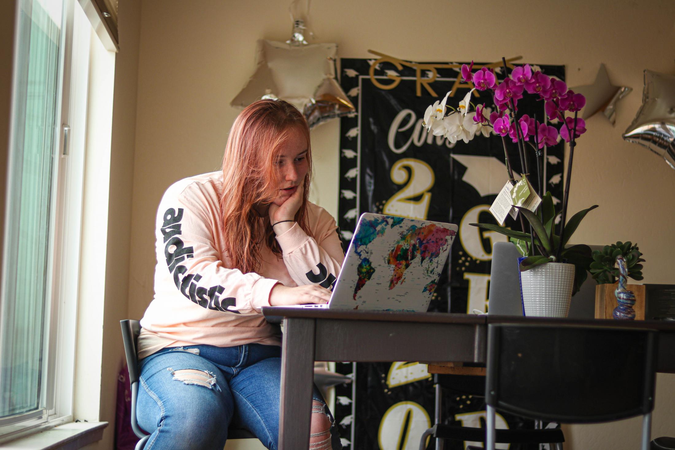 Hannah Khorassani reads about COVID-19 symptoms on her laptop, at her residence in Daly City, Calif., on July 19, 2020. (Harika Maddala/ Golden...