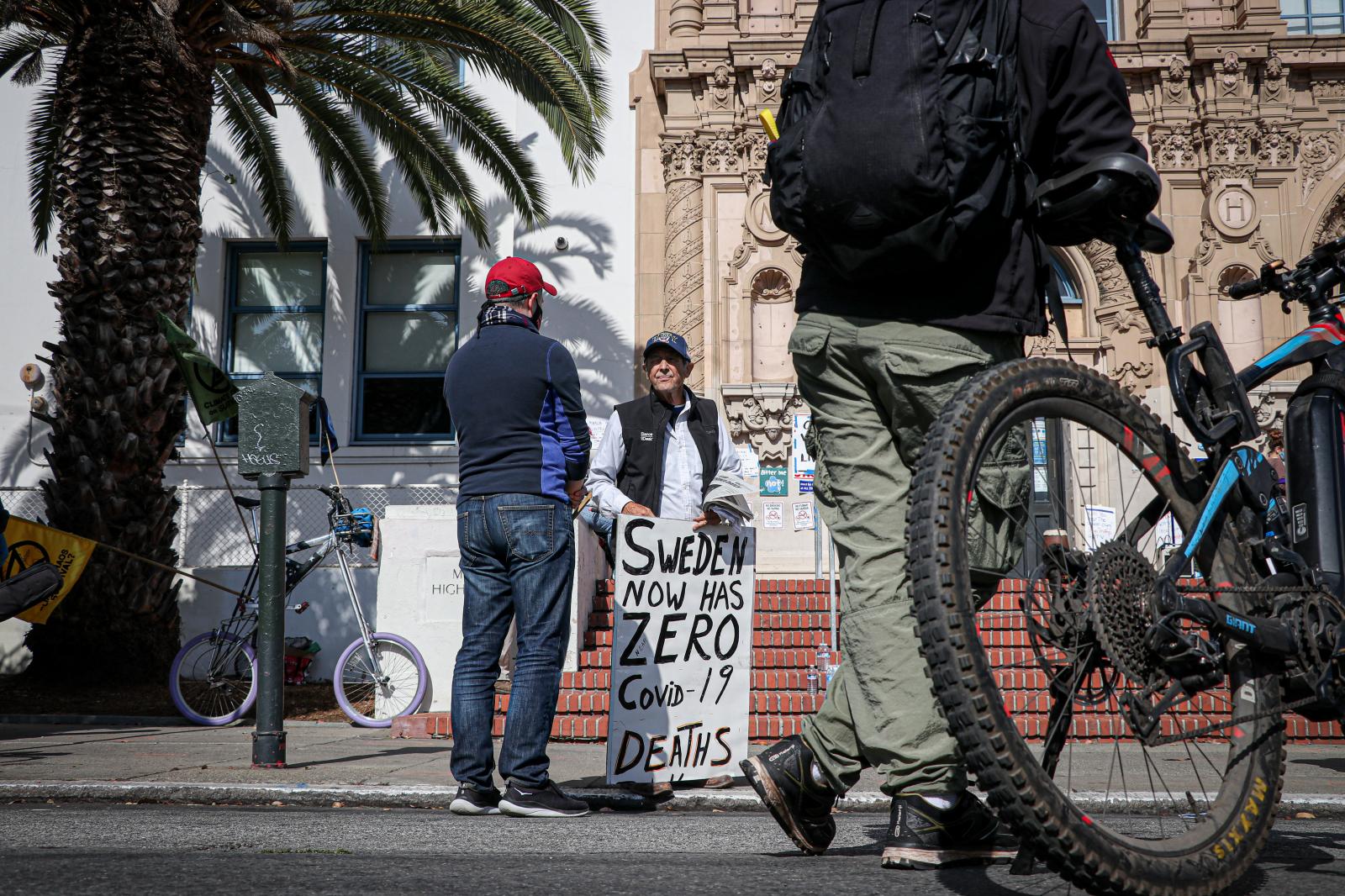 A man holding a sign that read ...ka Maddala/ Golden Gate Xpress)