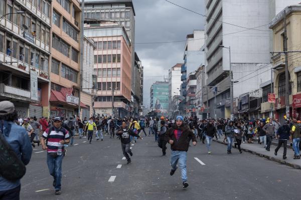 Demonstrators run along 10 de Agosto Avenue on the afternoon of October 4, 2019, in response to the arrival of anti-riot squads of the national police. The social outburst of those weeks showed the new control mechanisms of the police force. Quito, Ecuador.  