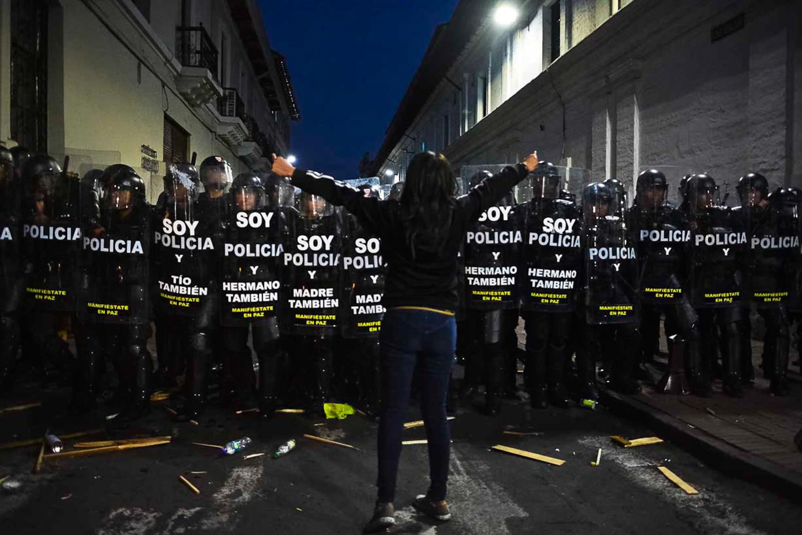 COVERAGES - A demonstrator faces a police squad blocking Sebastian de...