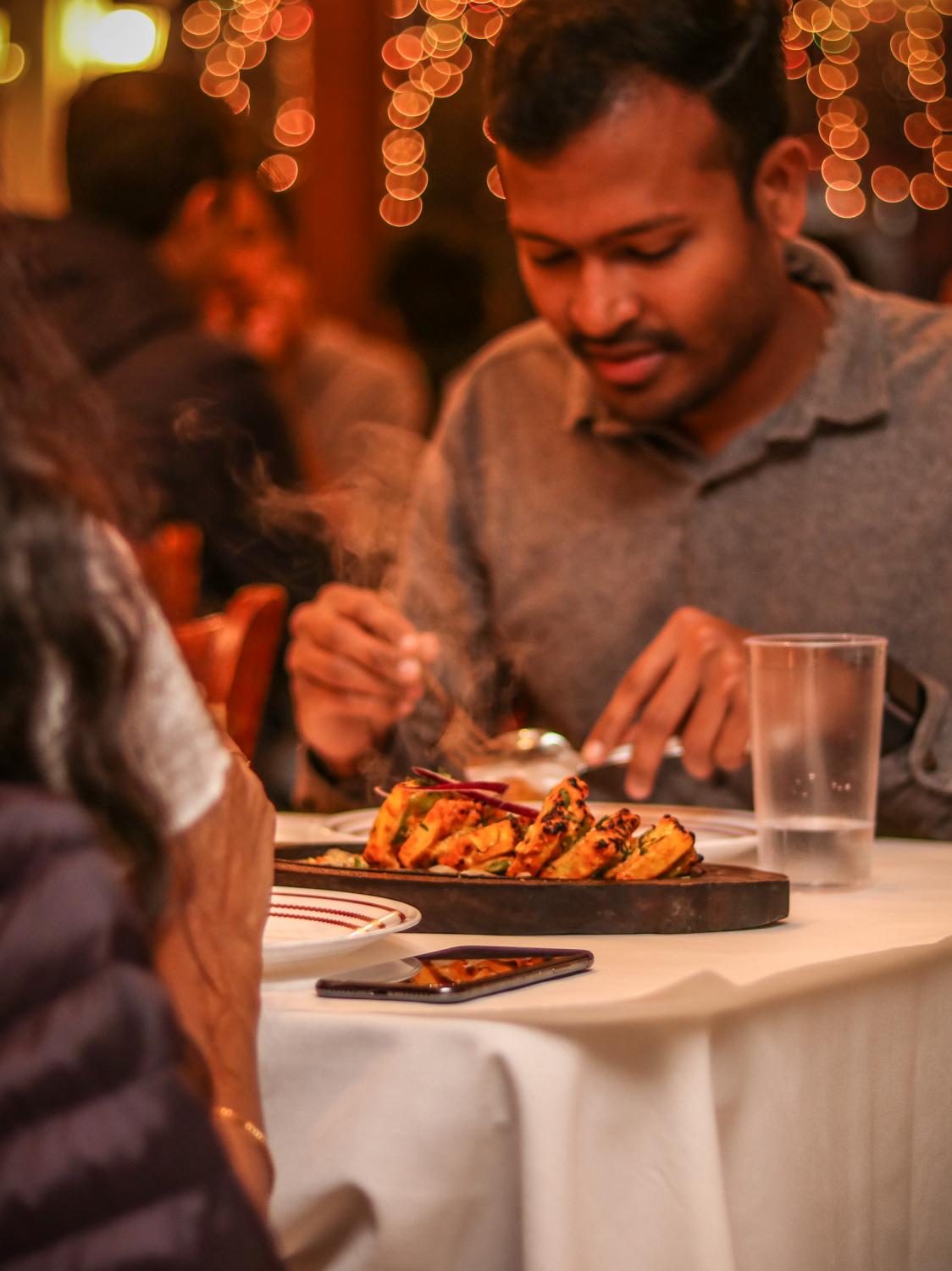 Indian Food - Customer eats Paneer Tikka at Palamuru Grill in Santa...
