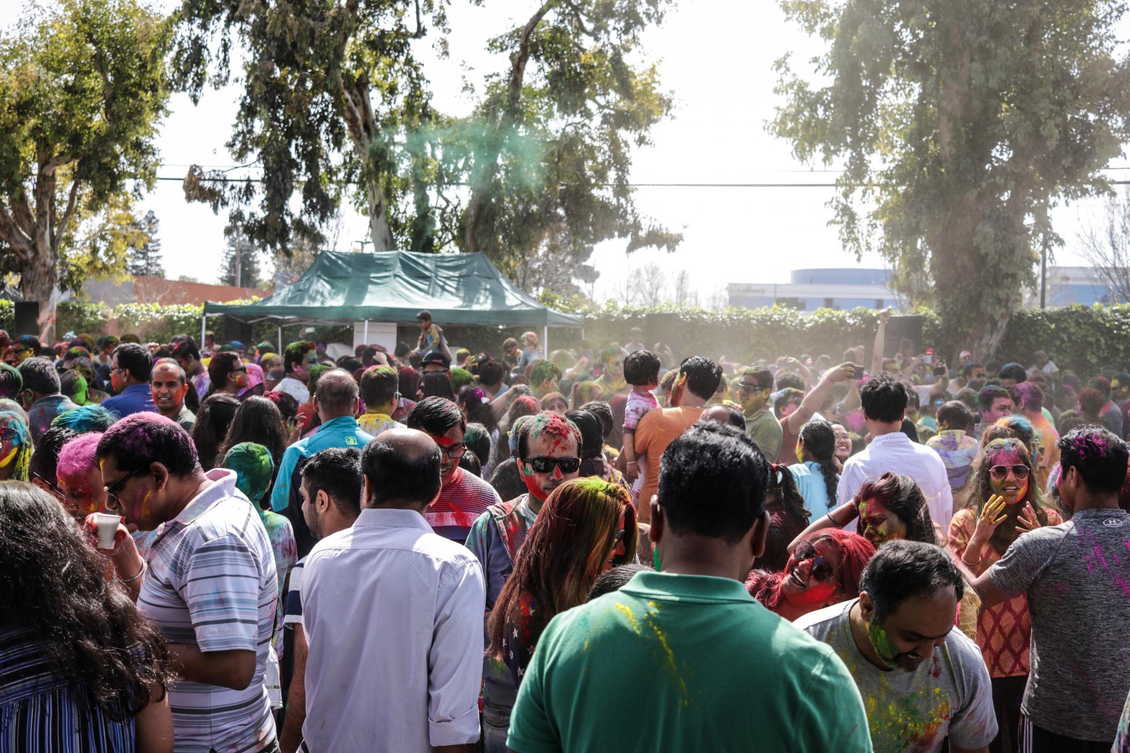 Holi- Festival of colors - Crowd plays with colors during Holi celebrations at Shiv...