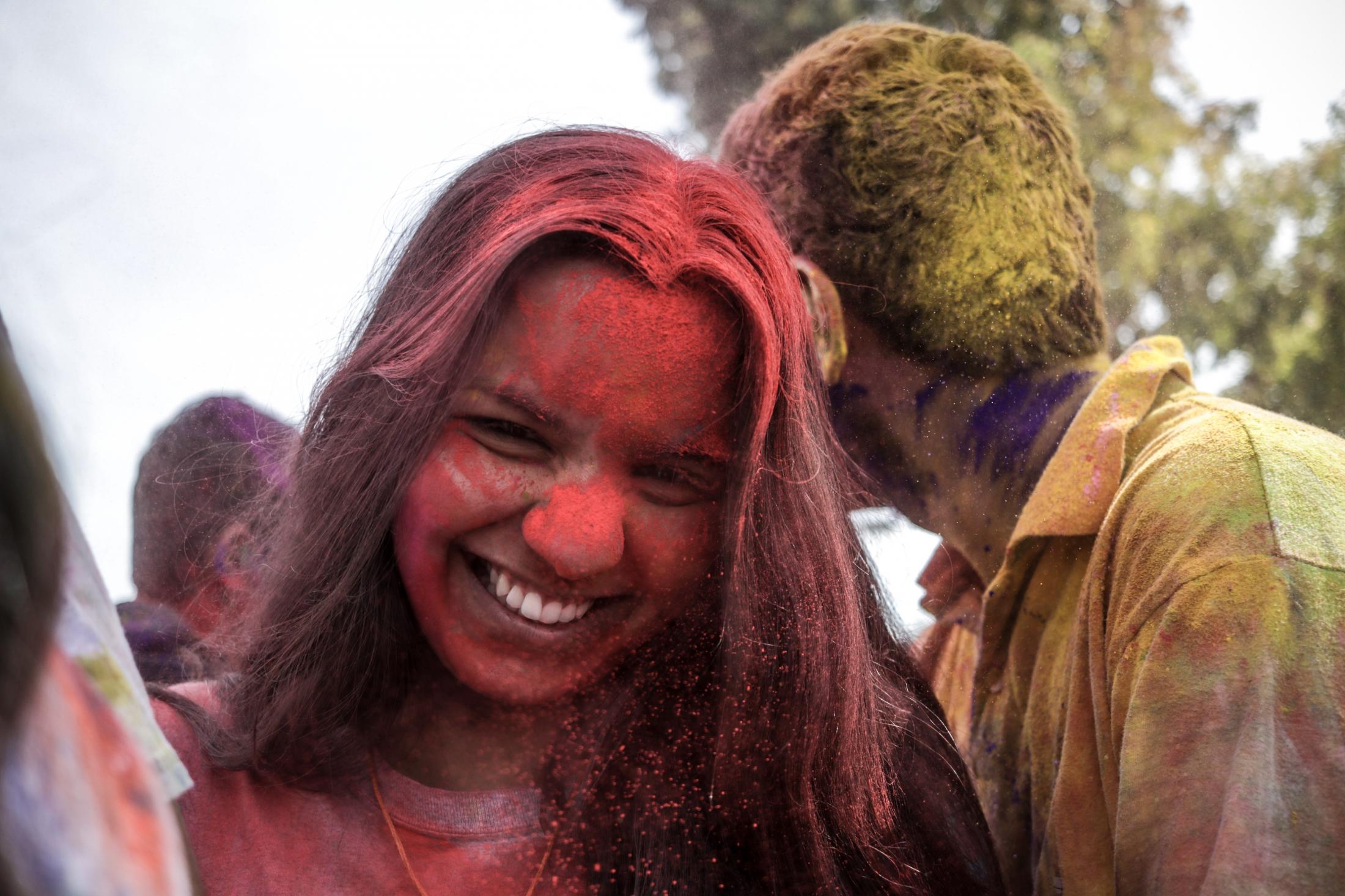 Holi- Festival of colors - Ananya, 21, laughs as her friend just threw color at her,...