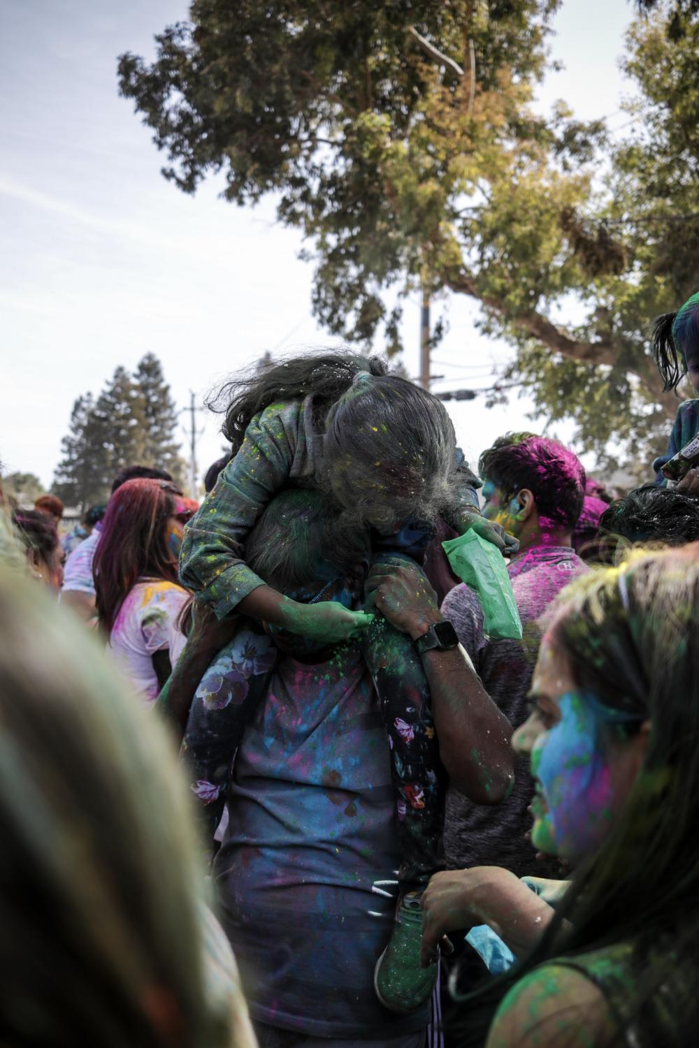 Holi- Festival of colors - Chakrika, 7, puts color on her father, Pavan, at Holi...
