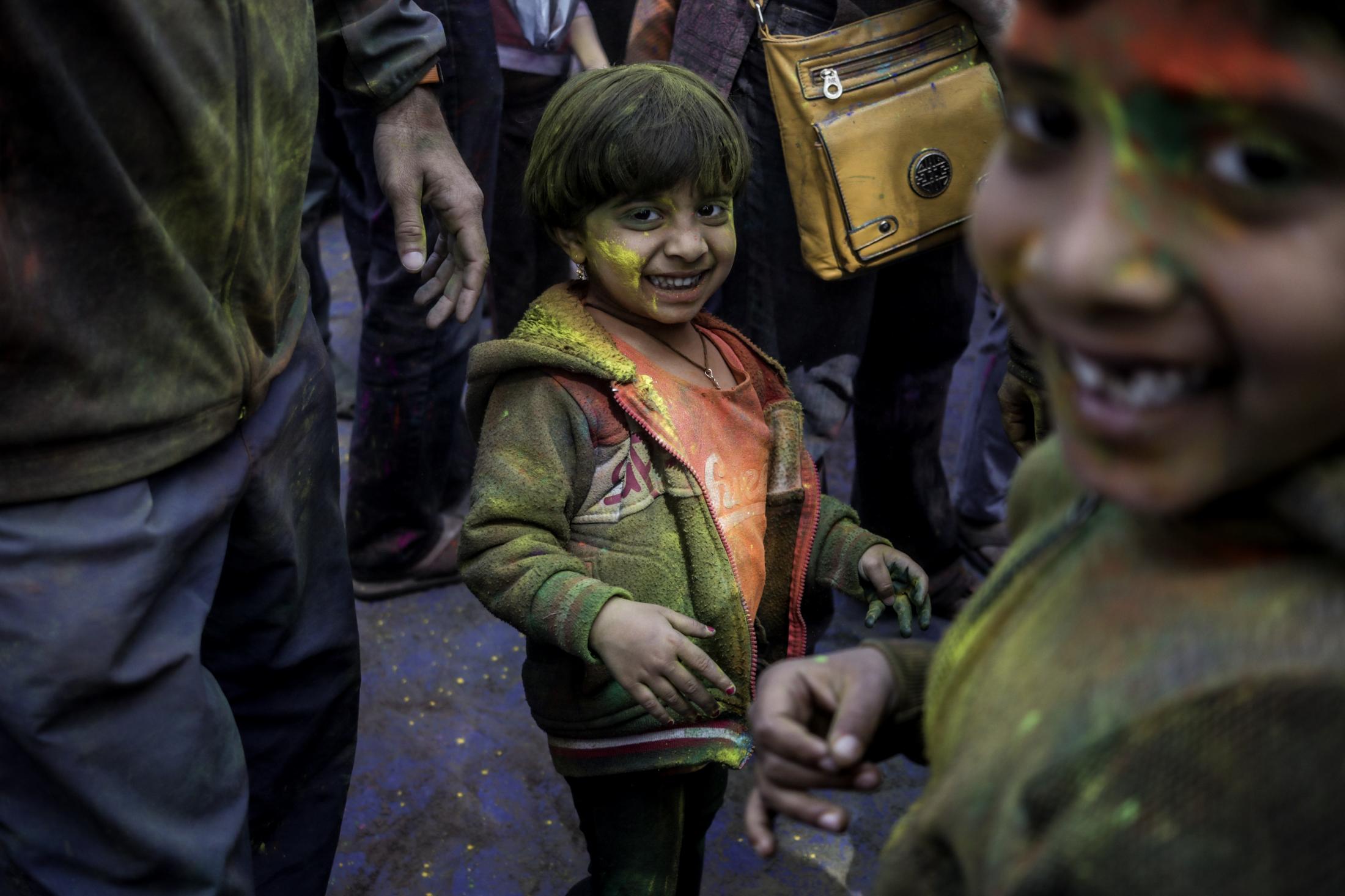 Holi- Festival of colors - Aarya,4, smiles at camera at the Holi celebrations at...