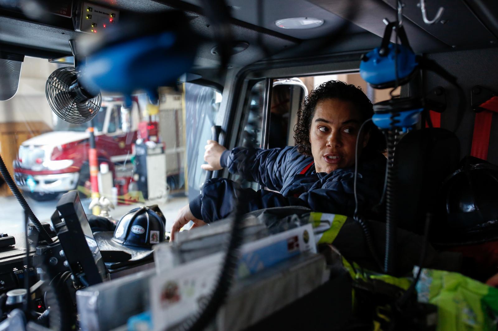Female Firefighters - Lieutenant Julie DeJarlais communicates with her crew as...
