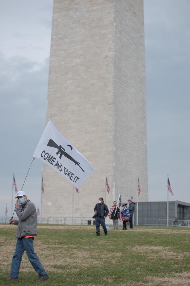 Pro-Trump rally-goers wait for ...ext to the Washington Monument.