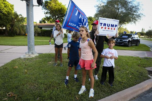 Supporters of President Donald Trump rally in front of poll station at Coral Gable Branch Public Library in Miami, Florida on November 3, 2020. Eva Marie UZCATEGUI