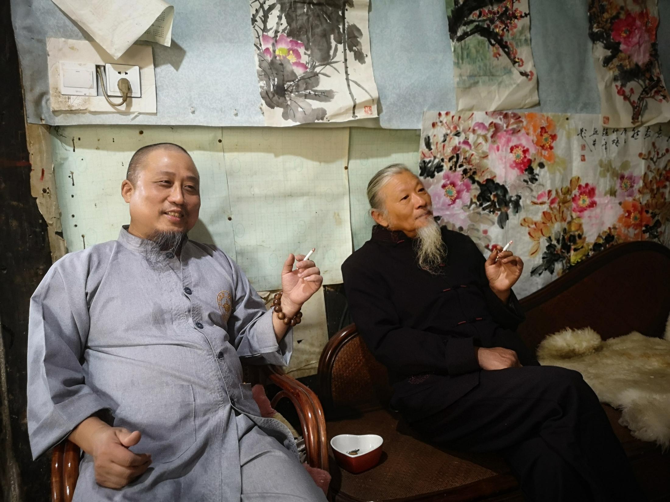 Qing Guo Alley's Big Bet - Pan Zaisheng and Zhao Yi Feng share cigarettes in...