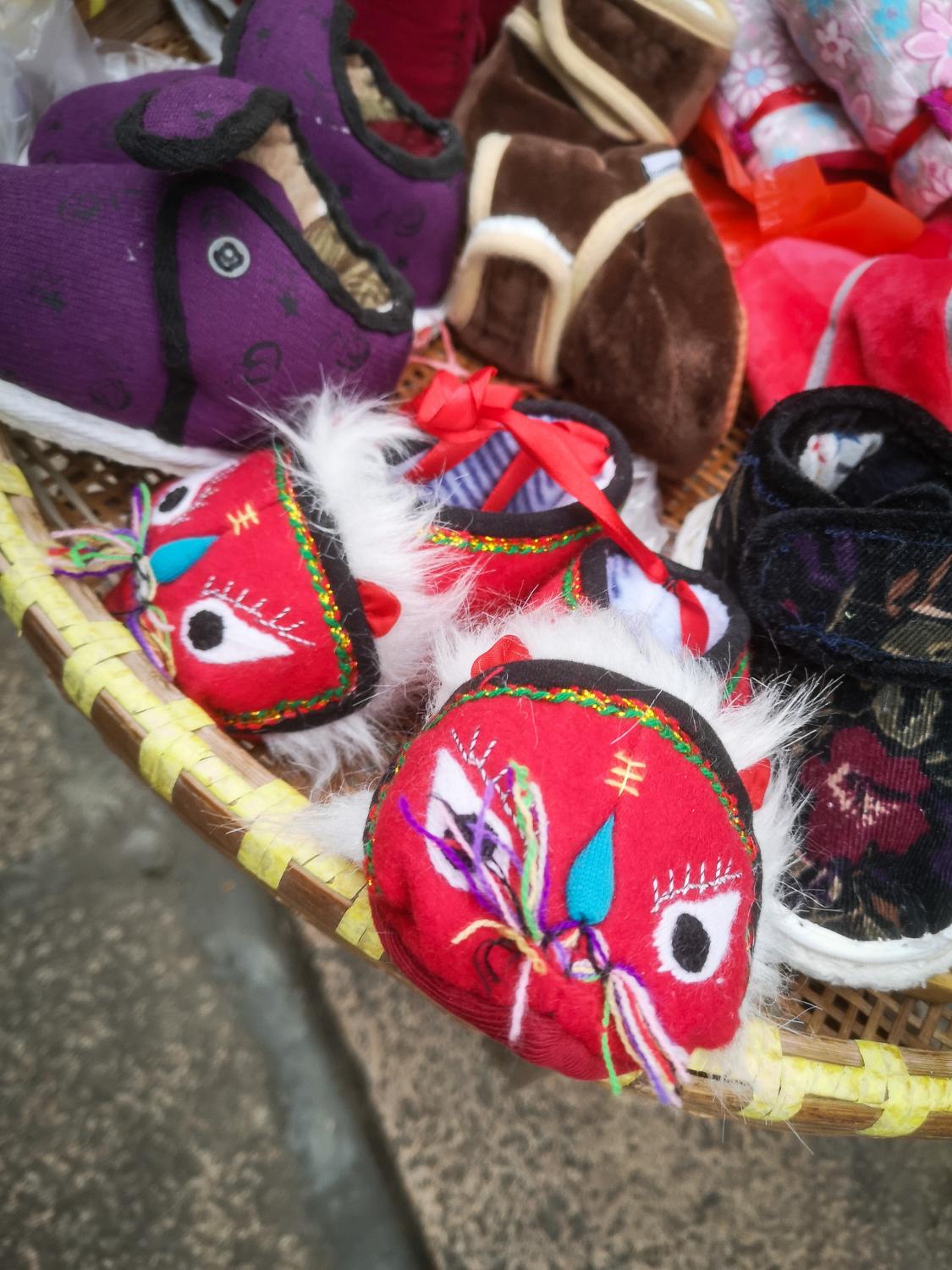 Qing Guo Alley's Big Bet - Lion slippers are traditional gifts in China for new...