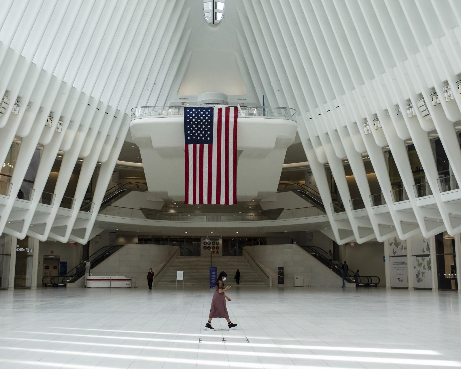 NEWS - A woman walks over to Manhattan's almost empty WTC...
