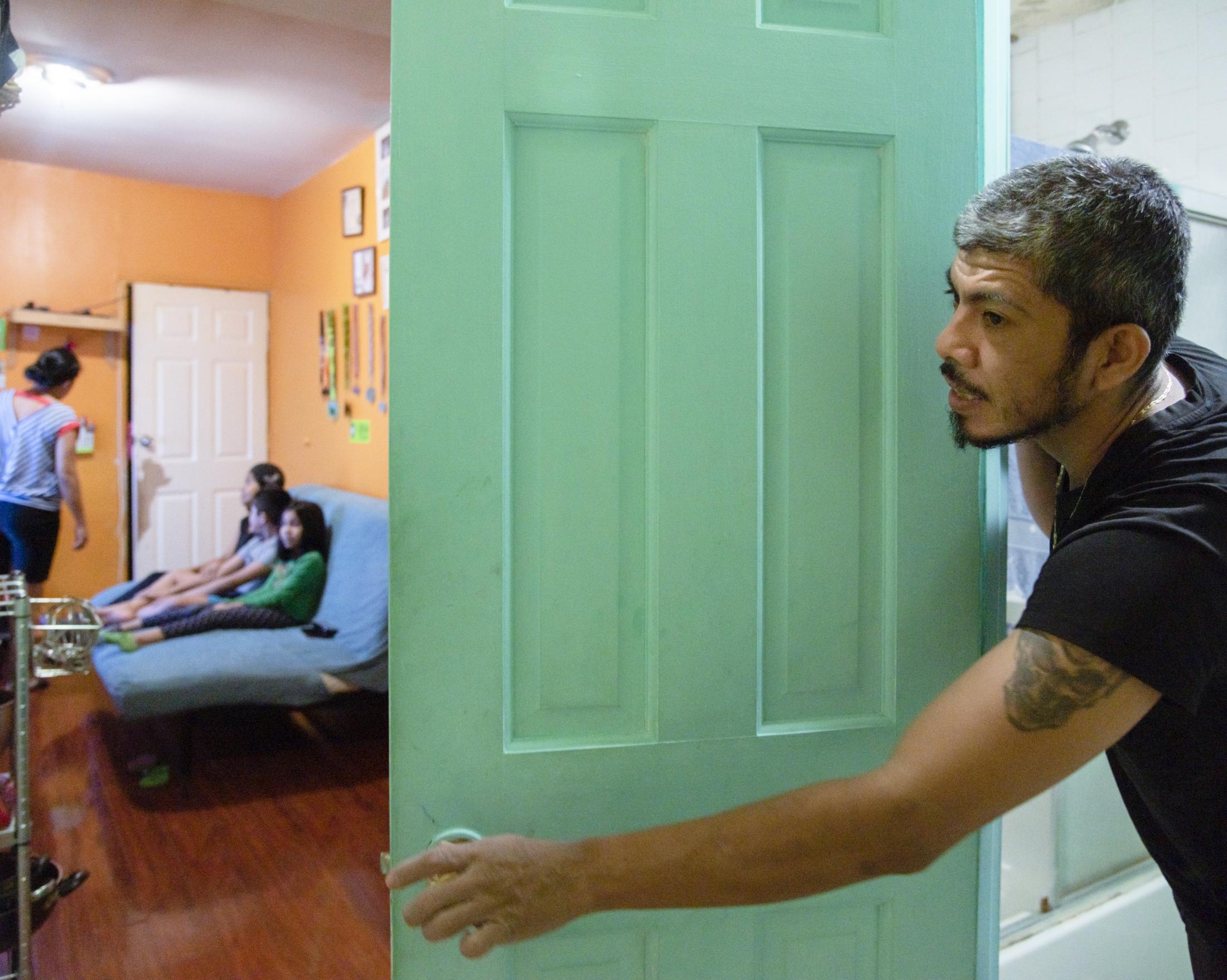 NYC Latino food delivery workers during COVID - Jaciel waits for towels and clean clothes while he is...