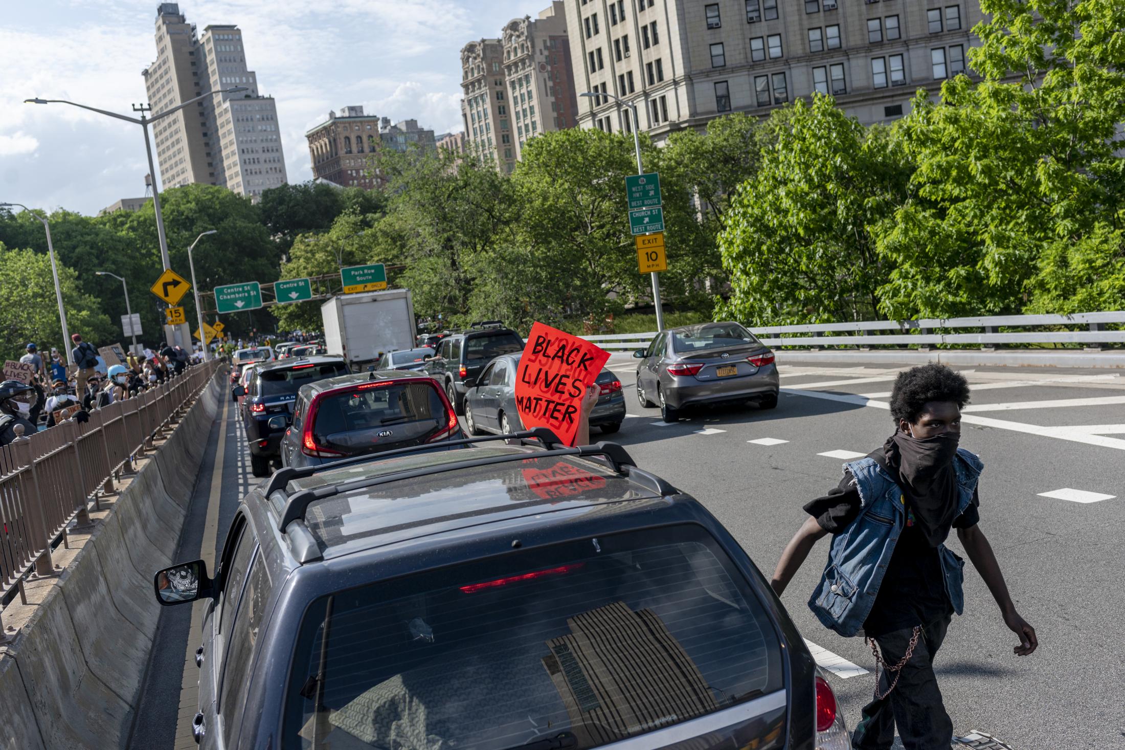 A man blocks an exit on the Brooklyn Bridge eastern side, on the first day of protests after the...